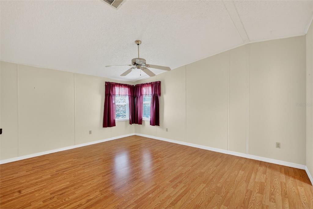 3324 Myakka River Road Tavares, FL 32778 - Photo 17 of 35 a view of an empty room with window and wooden floor