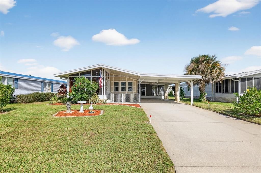 3324 Myakka River Road Tavares, FL 32778 - Photo 2 of 35 a front view of house with yard and green space