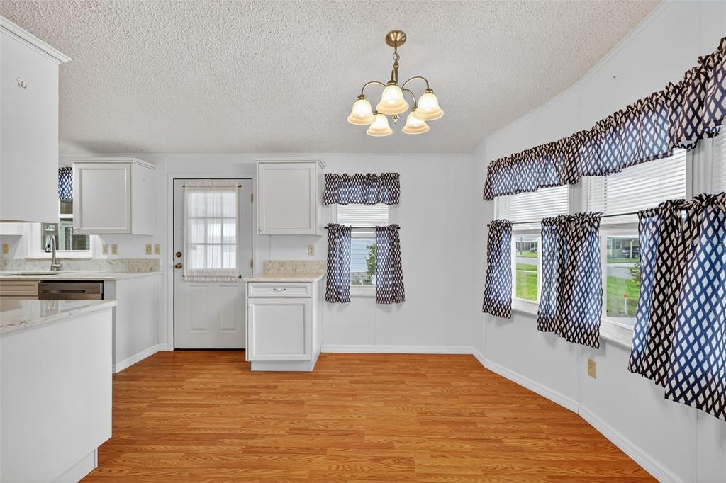 3324 Myakka River Road Tavares, FL 32778 - Photo 10 of 35 a view of a kitchen with a sink dishwasher and fireplace
