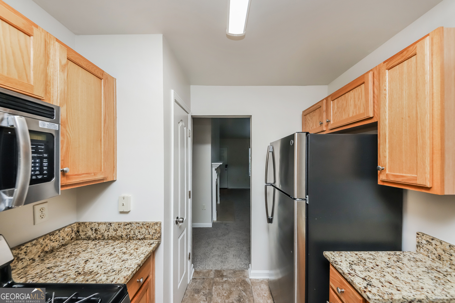 102 Rocky Branch Way Villa Rica, GA 30180 - Photo 13 of 16 a kitchen with stainless steel appliances granite countertop a refrigerator and a stove top oven