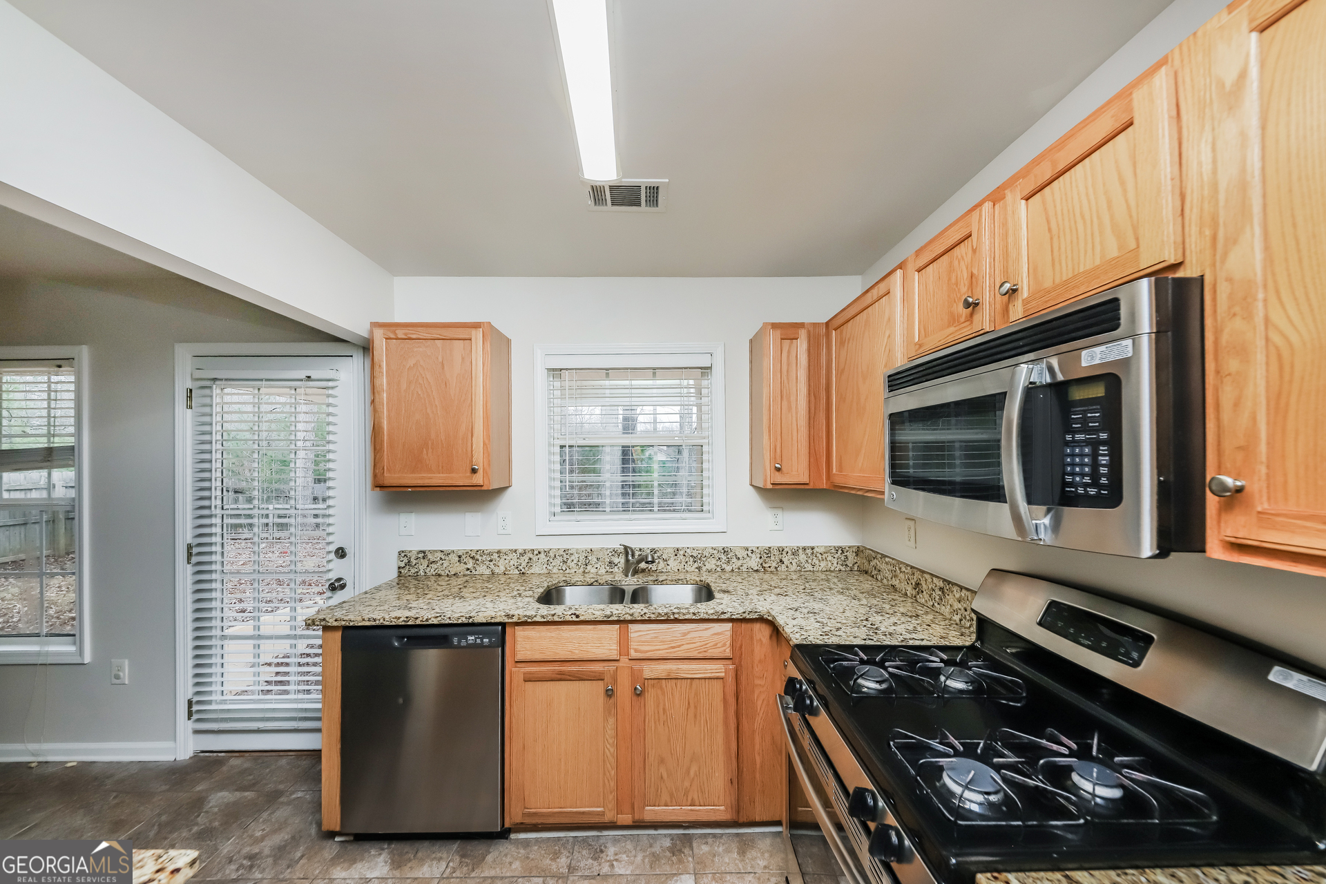 102 Rocky Branch Way Villa Rica, GA 30180 - Photo 14 of 16 a kitchen with stainless steel appliances granite countertop a stove and a sink