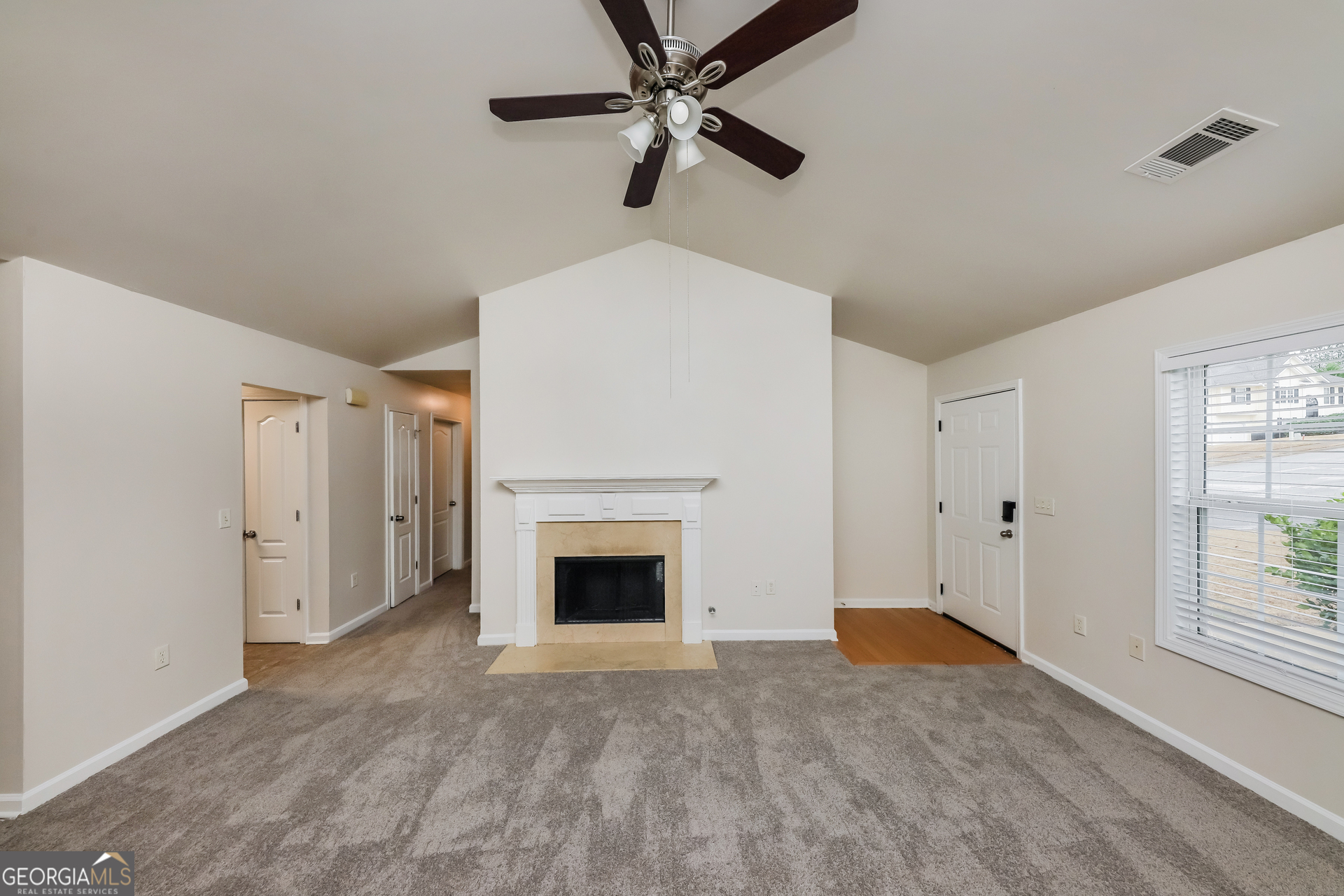 102 Rocky Branch Way Villa Rica, GA 30180 - Photo 4 of 16 a view of a livingroom with a fireplace a ceiling fan and hardwood floor
