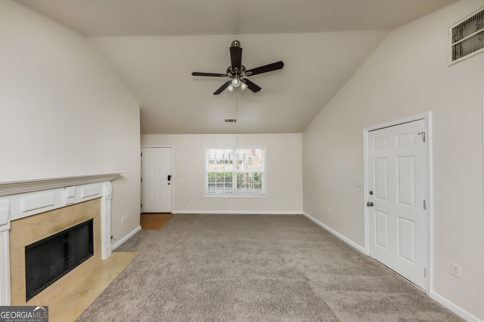 102 Rocky Branch Way Villa Rica, GA 30180 - Photo 5 of 16 wooden floor in an empty room with a fireplace