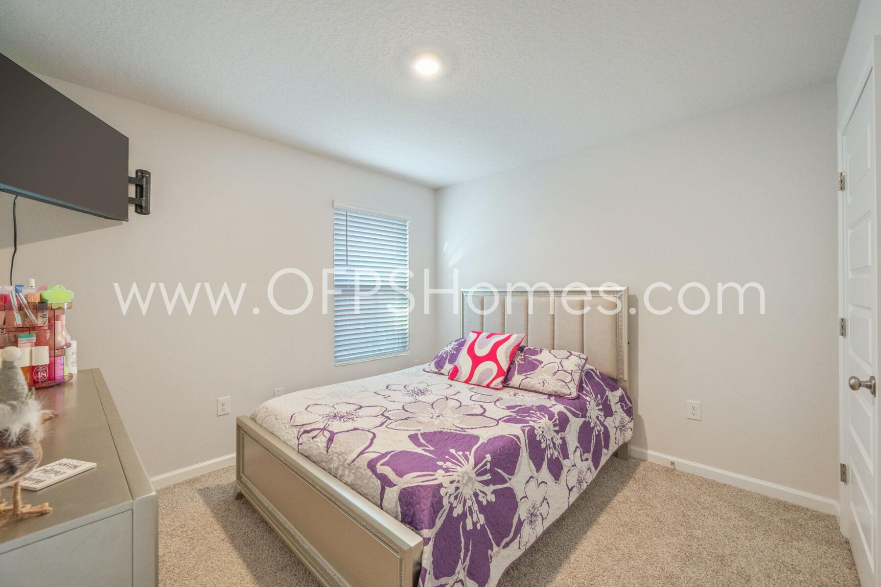 4618 Naval Court Crestview, FL 32539 - Photo 23 of 34 a bedroom with a bed and a table