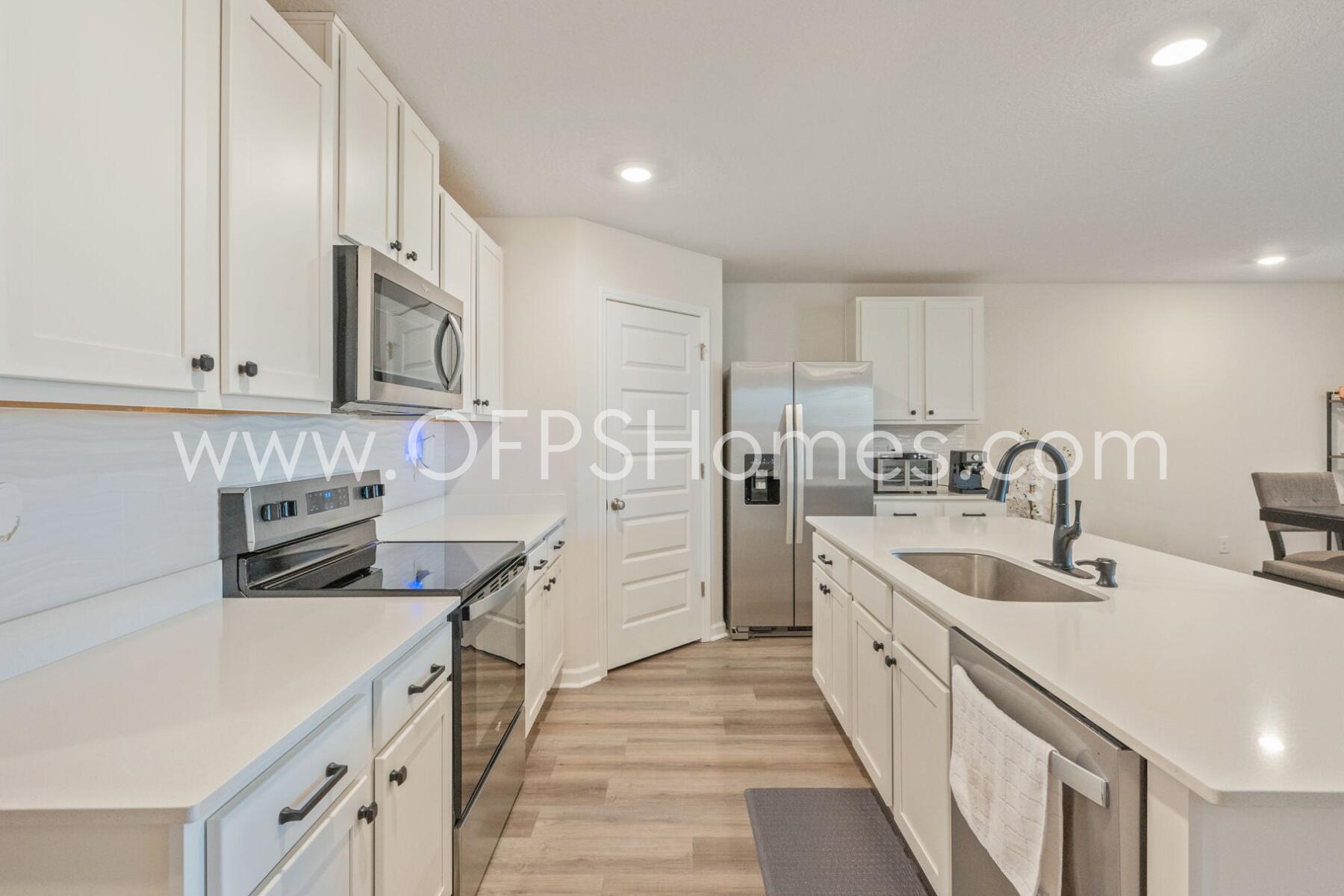 4618 Naval Court Crestview, FL 32539 - Photo 8 of 34 a kitchen with stainless steel appliances granite countertop a sink and cabinets