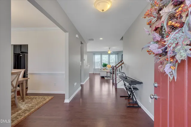 a view of a hallway with wooden floor and stairs