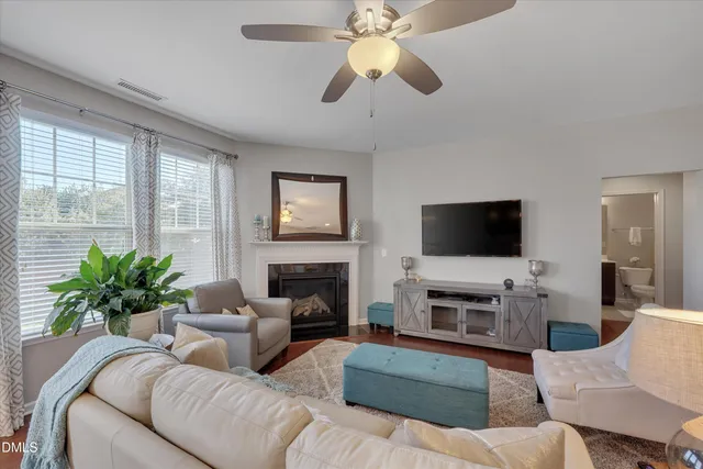 a living room with furniture a fireplace and a flat screen tv