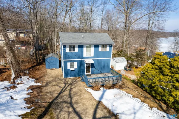 a view of a house with a yard covered in snow