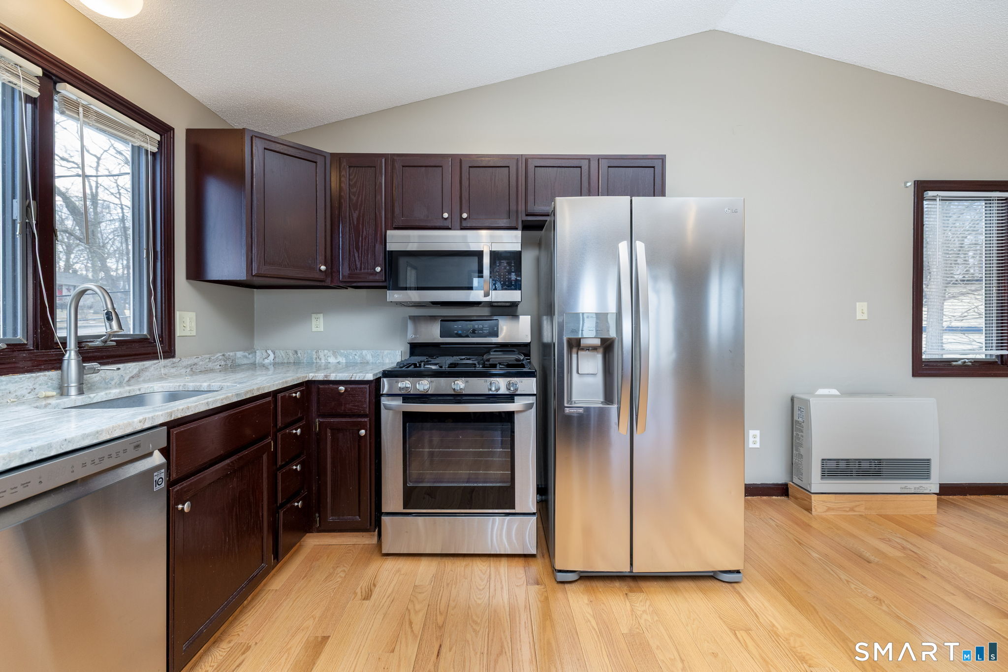 12 Rondaly Road Hebron, CT 06231 - Photo 12 of 33 a kitchen with stainless steel appliances granite countertop a refrigerator a sink a stove a microwave and wooden cabinets