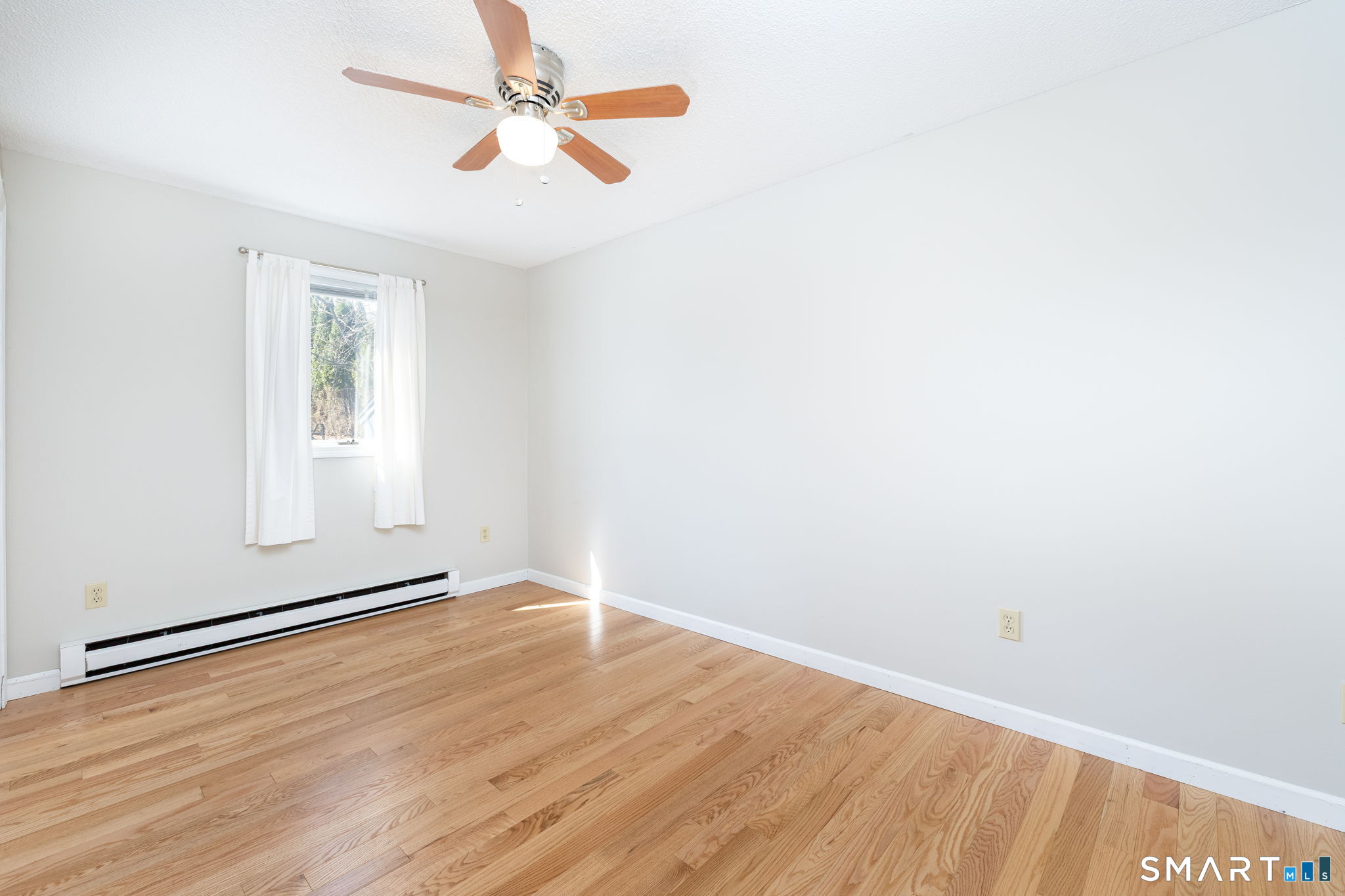 12 Rondaly Road Hebron, CT 06231 - Photo 13 of 33 an empty room with wooden floor chandelier fan and windows