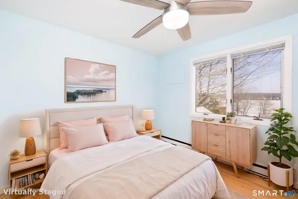 a bedroom with a large bed and a window