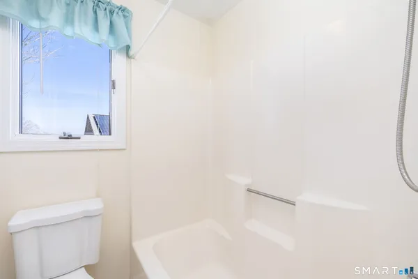 a bathroom with a bathtub and a toilet