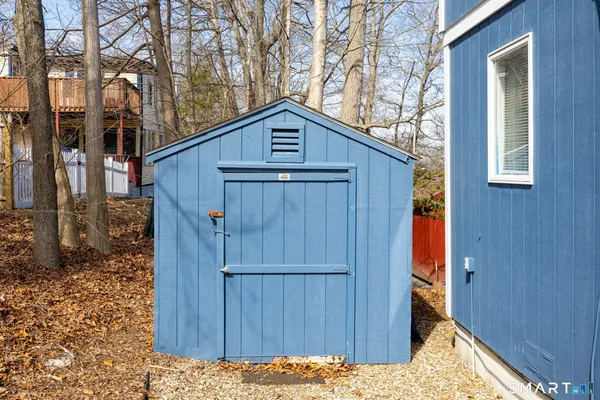 a view of wooden house and a yard