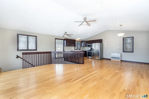 a view of a bedroom with wooden floor