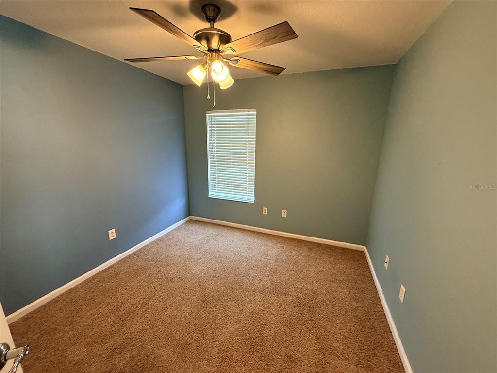4199 Southwest 46th Court Ocala, FL 34474 - Photo 35 of 50 an empty room with a chandelier fan and windows