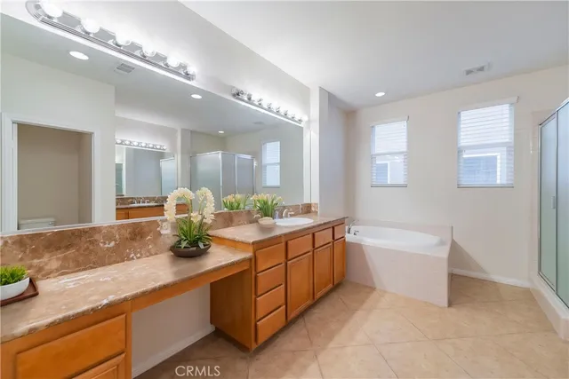 a bathroom with a granite countertop sink a mirror and a shower