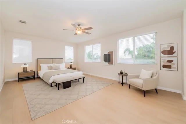 a bed room with furniture and a wooden floor