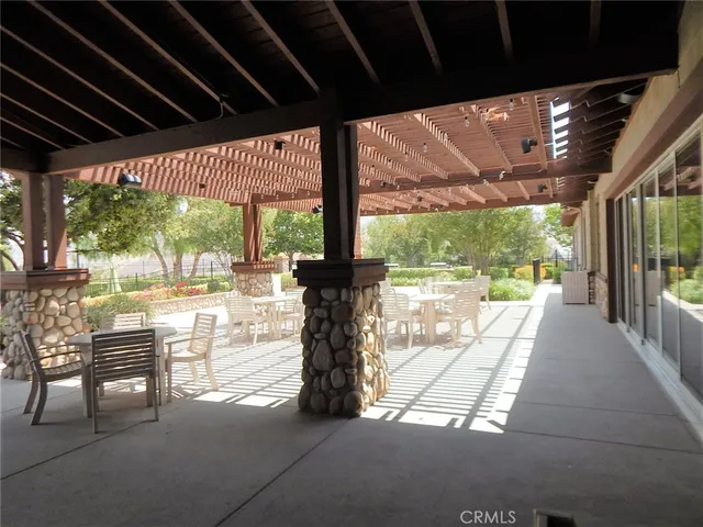 a view of house with outdoor seating and green space