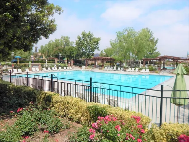 a view of a swimming pool with outdoor seating and plants