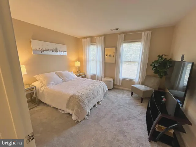 a spacious bedroom with a bed and furniture