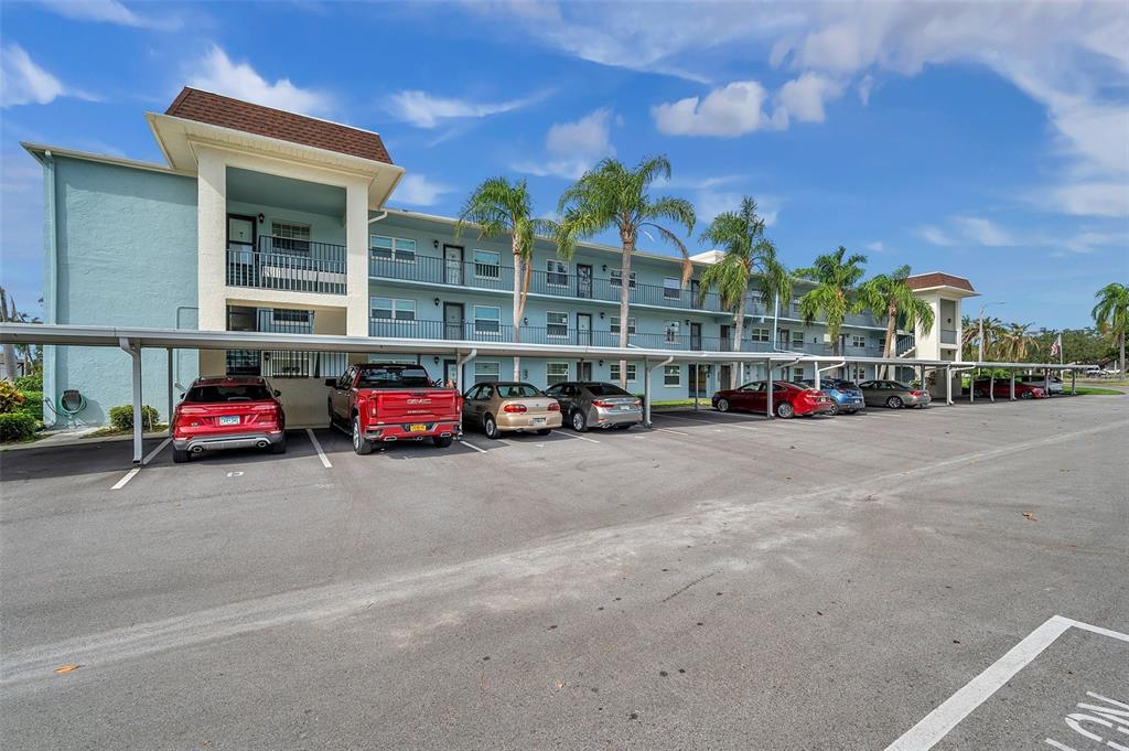 1430 Heather Ridge Boulevard, Unit 304 Dunedin, FL 34698 - Photo 30 of 36 a car parked in front of a building