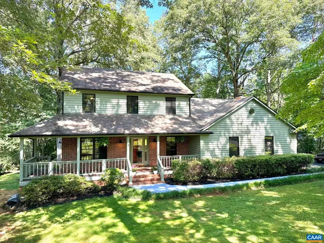 a front view of a house with a yard table and chairs