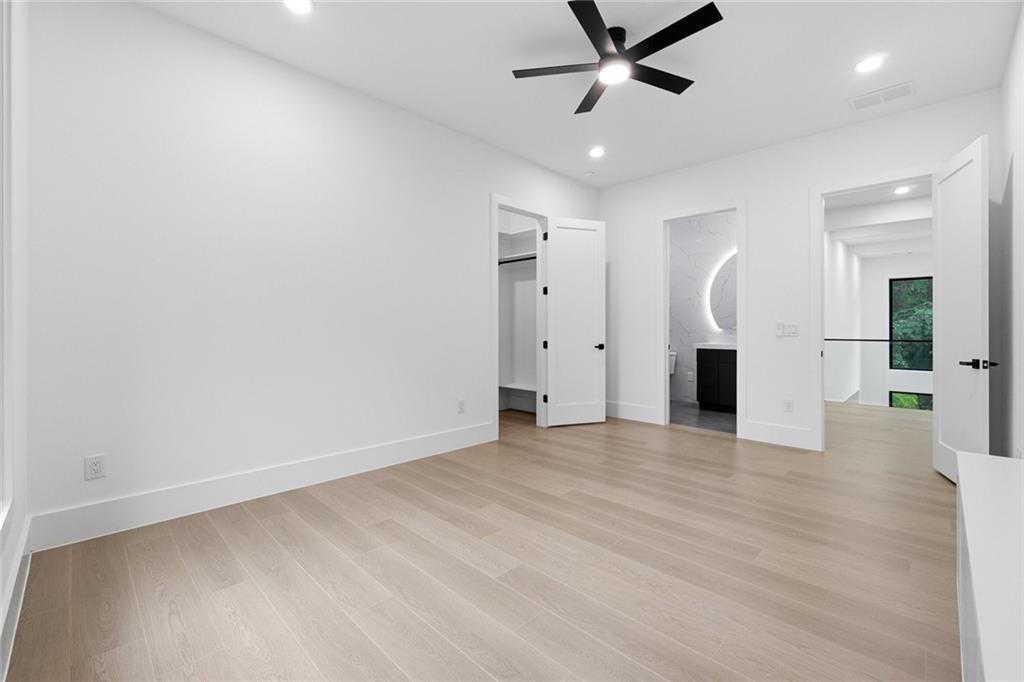 1563 Whitley Road Dacula, GA 30019 - Photo 15 of 44 an empty room with wooden floor and a ceiling fan