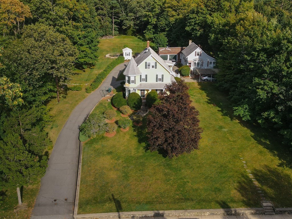 727 Main Street Woburn, MA 01801 - Photo 1 of 40 a view of a house with a yard and large trees