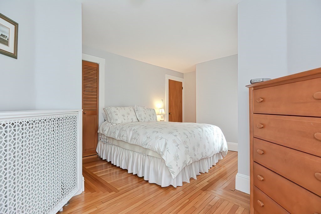 727 Main Street Woburn, MA 01801 - Photo 16 of 40 a bedroom with a bed and a dresser