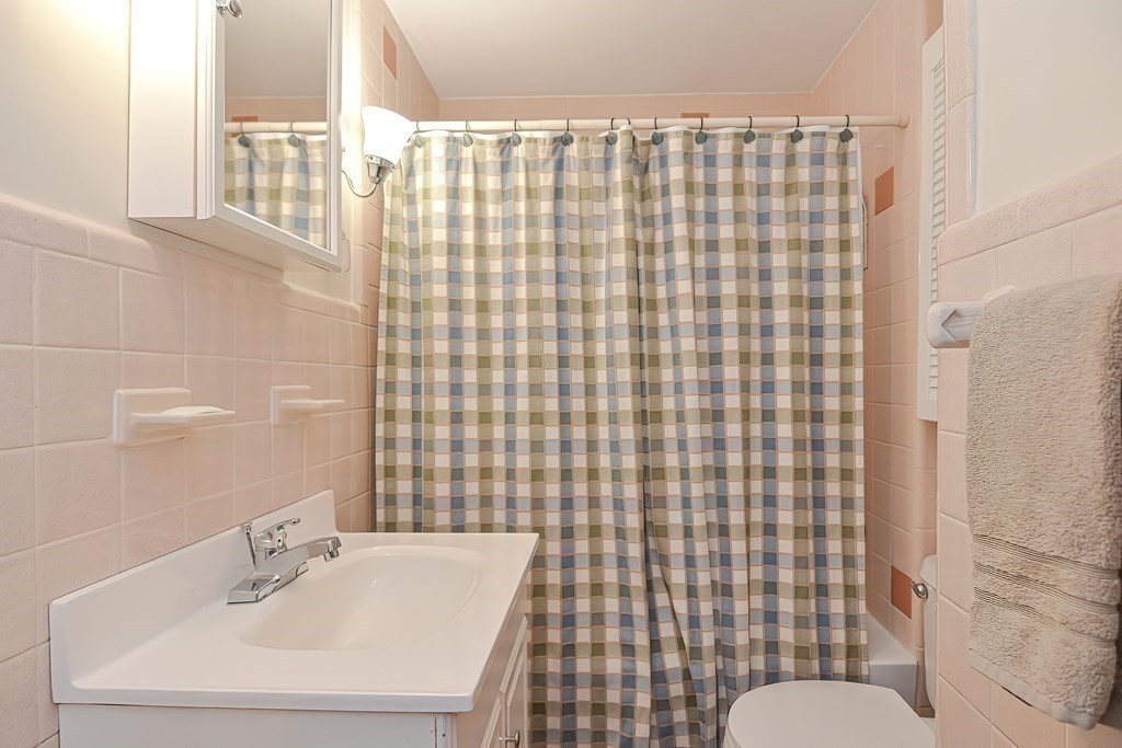 727 Main Street Woburn, MA 01801 - Photo 17 of 40 a bathroom with a sink a toilet and shower