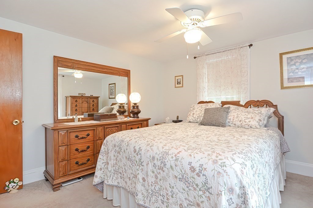 727 Main Street Woburn, MA 01801 - Photo 18 of 40 a spacious bedroom with a bed and a dresser