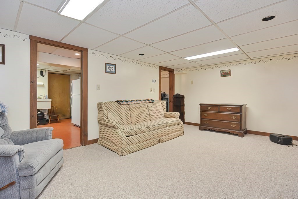 727 Main Street Woburn, MA 01801 - Photo 19 of 40 a living room with furniture a air conditioner vent and white walls