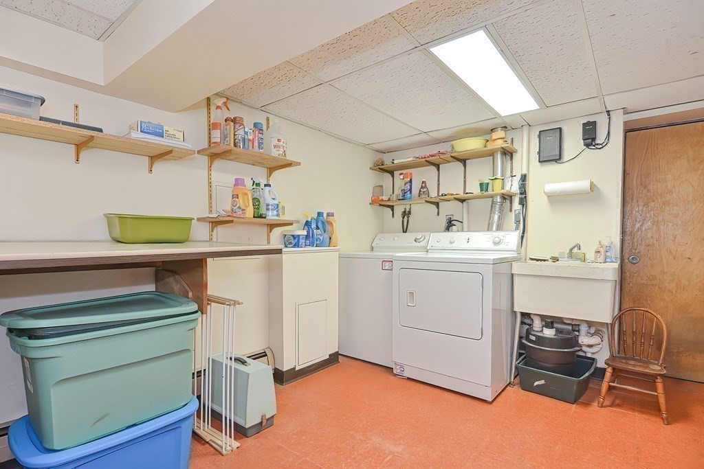 727 Main Street Woburn, MA 01801 - Photo 20 of 40 a utility room with cabinets washer and dryer