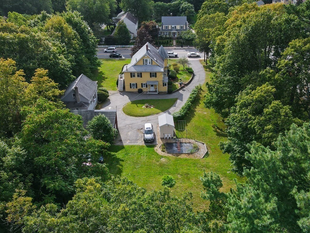 727 Main Street Woburn, MA 01801 - Photo 2 of 40 an aerial view of a house with outdoor space pool seating area and yard