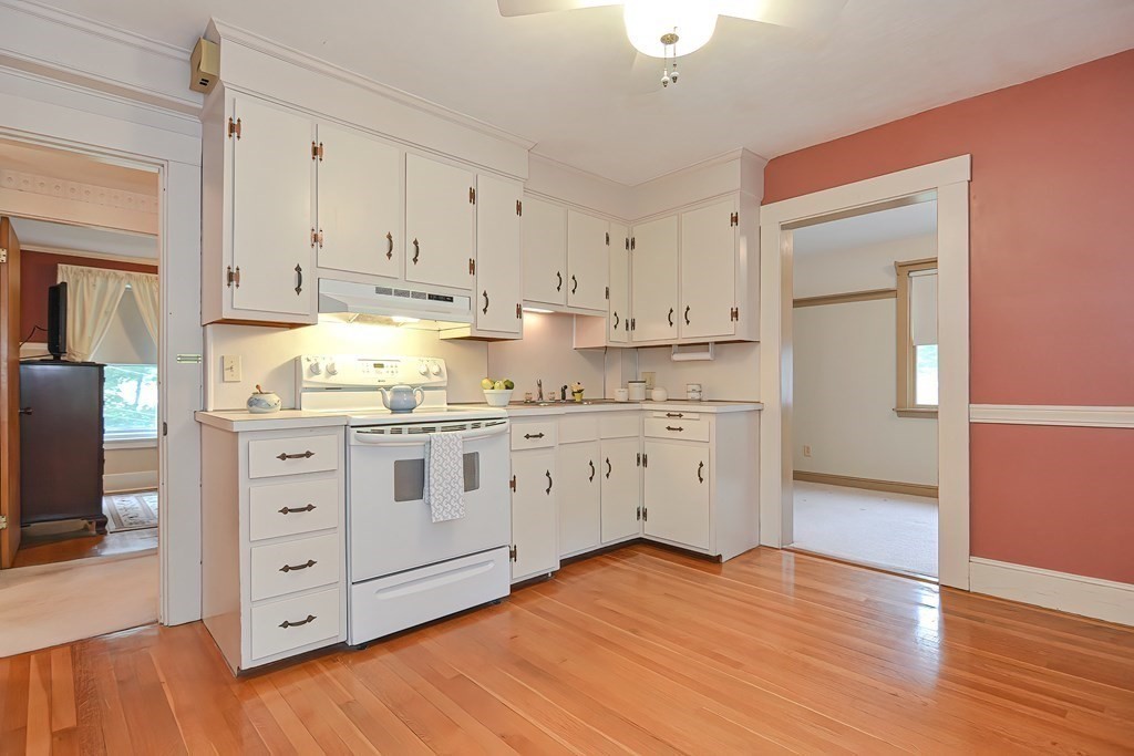 727 Main Street Woburn, MA 01801 - Photo 21 of 40 a kitchen with stainless steel appliances granite countertop a white cabinets and sink
