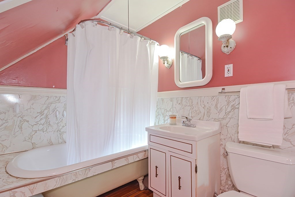 727 Main Street Woburn, MA 01801 - Photo 24 of 40 a bathroom with a sink vanity tub and a mirror