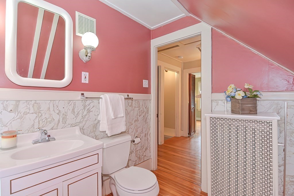 727 Main Street Woburn, MA 01801 - Photo 25 of 40 a bathroom with a sink a toilet and shower curtain