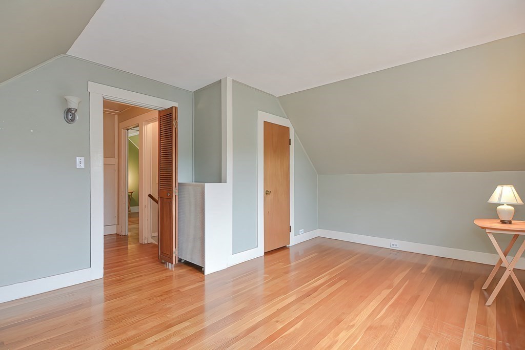 727 Main Street Woburn, MA 01801 - Photo 27 of 40 an empty room with wooden floor and closet