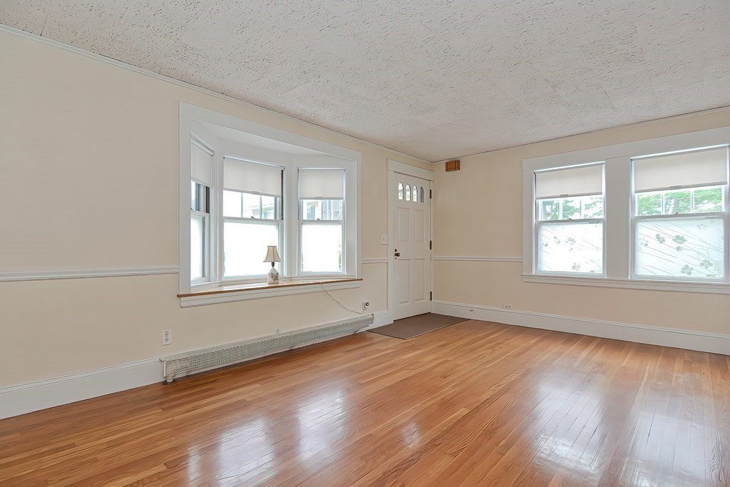 727 Main Street Woburn, MA 01801 - Photo 29 of 40 an empty room with wooden floor and windows