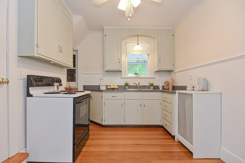 727 Main Street Woburn, MA 01801 - Photo 30 of 40 a kitchen with sink a microwave and cabinets