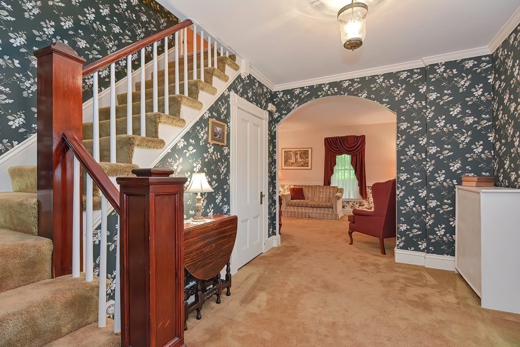 727 Main Street Woburn, MA 01801 - Photo 3 of 40 a view of livingroom with furniture and stairs