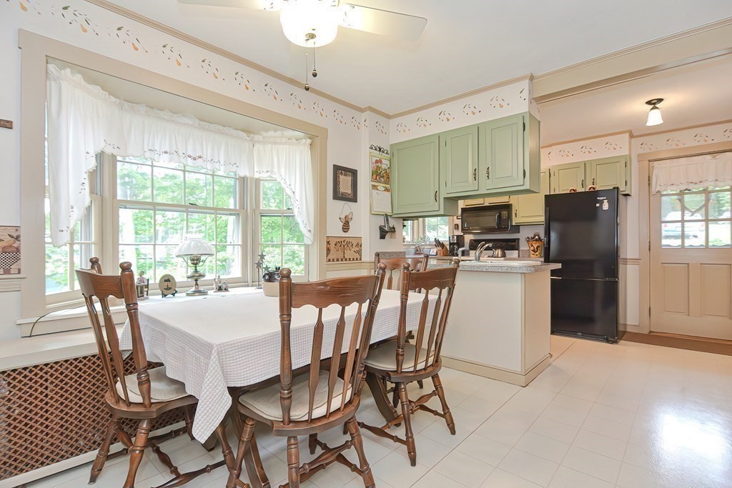 727 Main Street Woburn, MA 01801 - Photo 6 of 40 a view of a dining room with furniture a chandelier and wooden floor