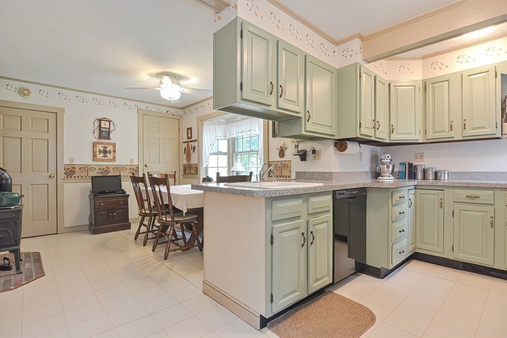 727 Main Street Woburn, MA 01801 - Photo 8 of 40 a kitchen with cabinets and chairs