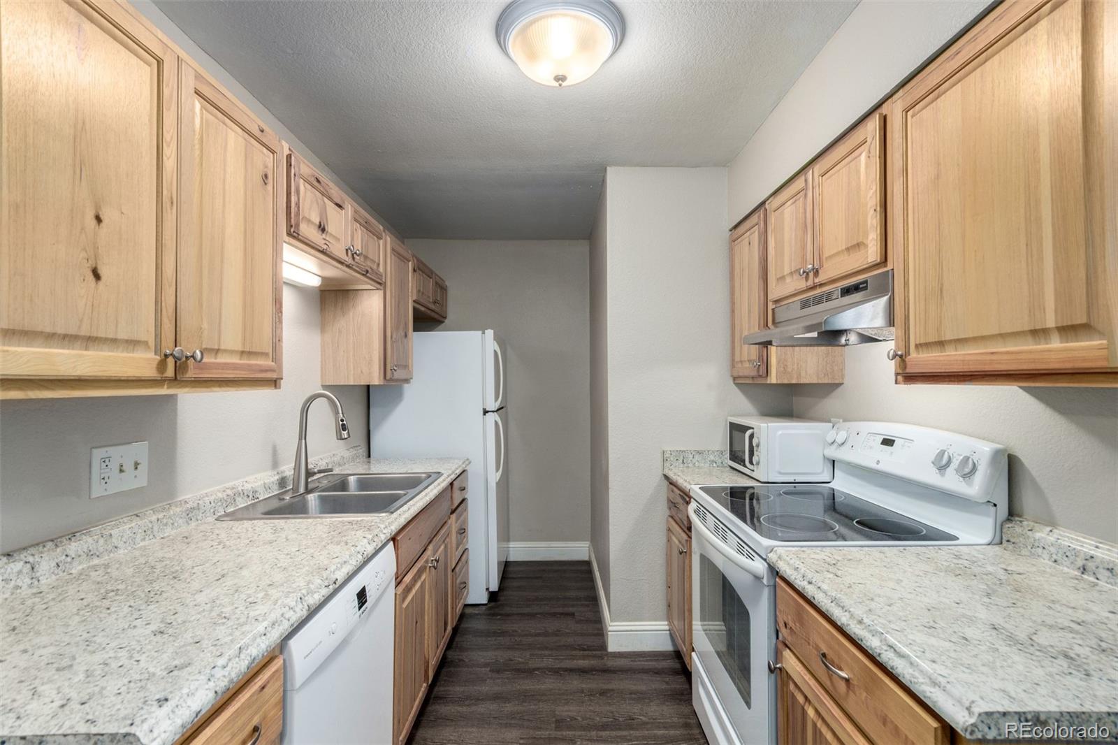 16359 West 10th Avenue, Unit O Golden, CO 80401 - Photo 11 of 25 a kitchen with a sink stove top oven and cabinets