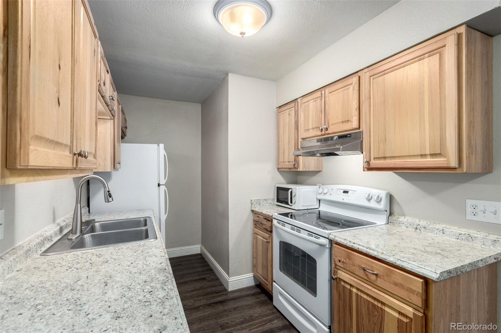 16359 West 10th Avenue, Unit O Golden, CO 80401 - Photo 12 of 25 a kitchen with stainless steel appliances granite countertop a sink stove and refrigerator