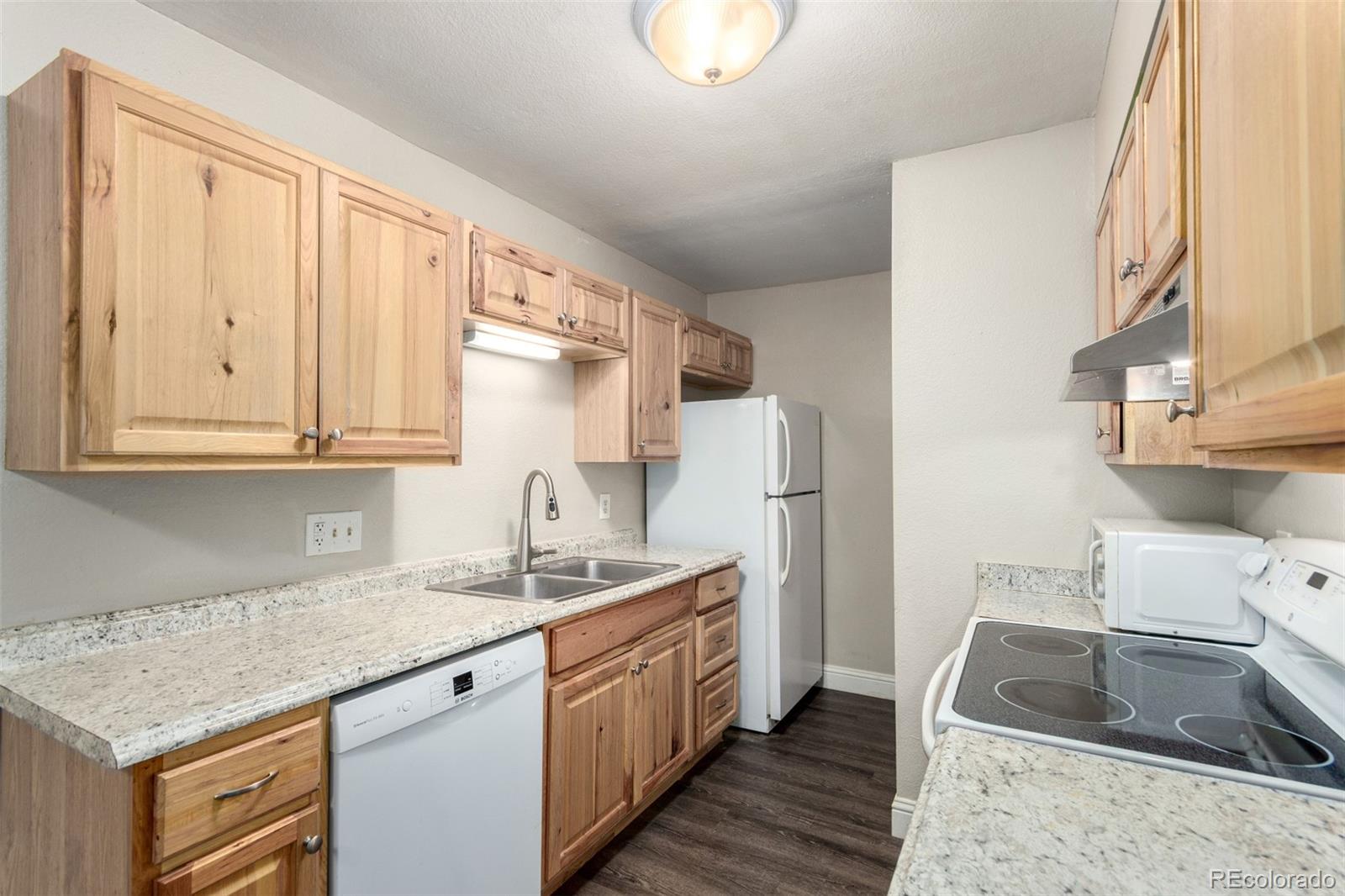 16359 West 10th Avenue, Unit O Golden, CO 80401 - Photo 13 of 25 a kitchen with a sink stove and refrigerator