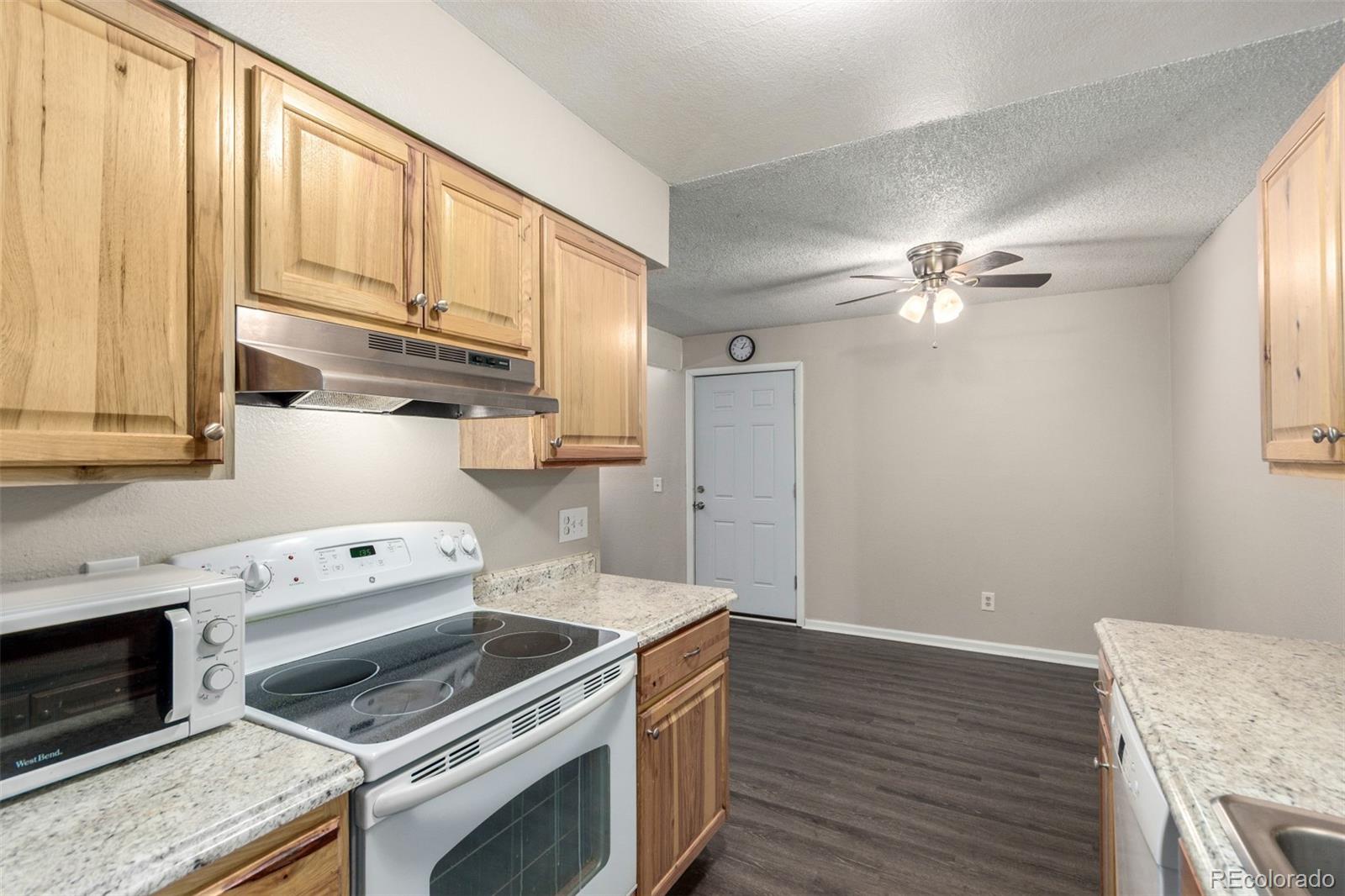 16359 West 10th Avenue, Unit O Golden, CO 80401 - Photo 15 of 25 a kitchen with a stove cabinets and wooden floor
