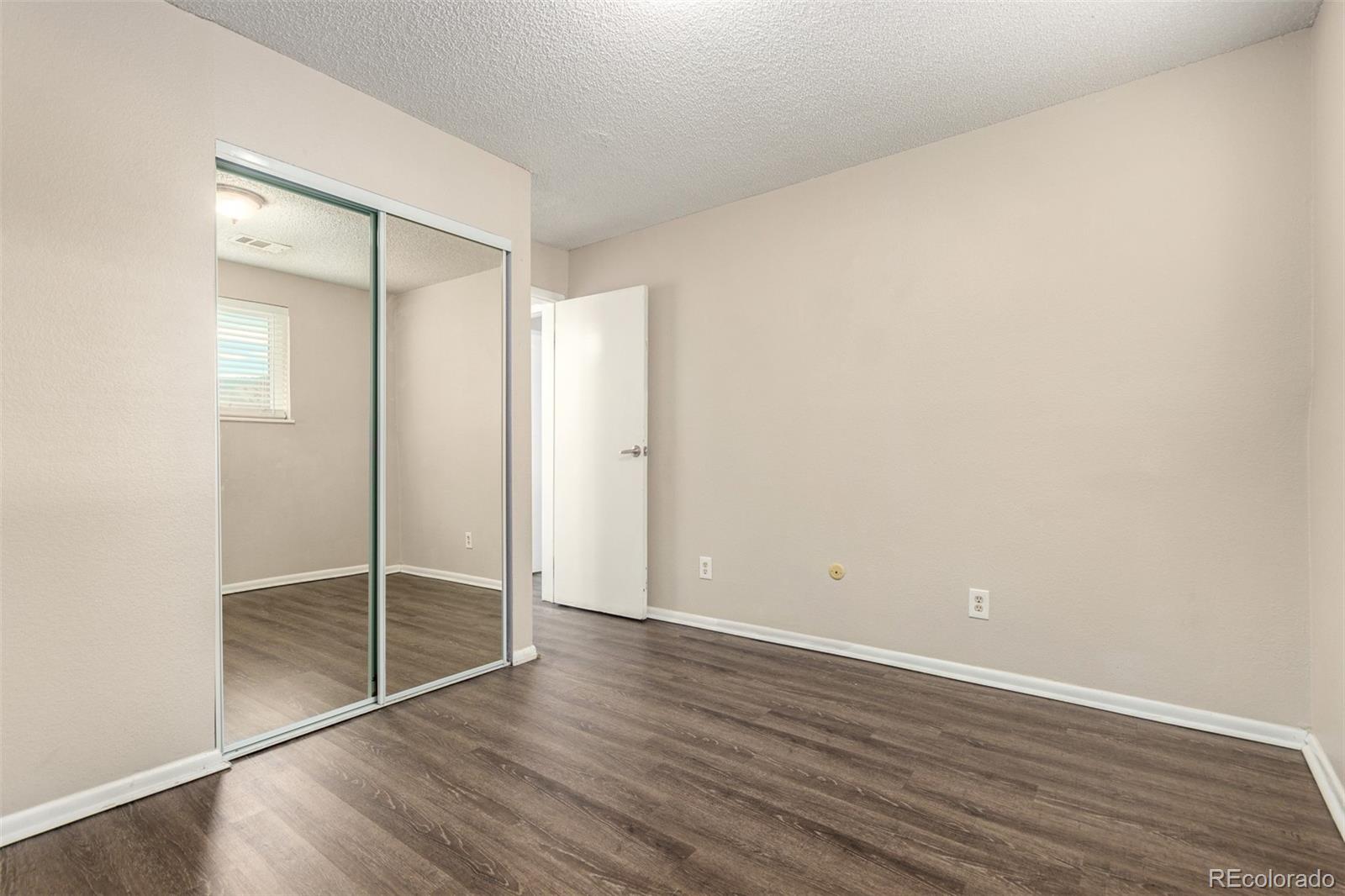 16359 West 10th Avenue, Unit O Golden, CO 80401 - Photo 18 of 25 a view of an empty room with wooden floor