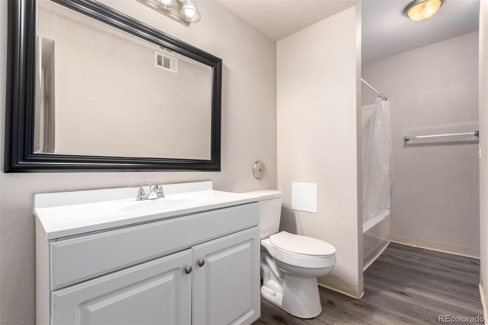16359 West 10th Avenue, Unit O Golden, CO 80401 - Photo 19 of 25 a bathroom with a toilet a sink and a mirror