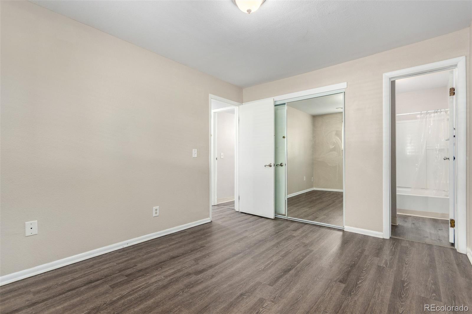 16359 West 10th Avenue, Unit O Golden, CO 80401 - Photo 22 of 25 an empty room with wooden floor & closet area